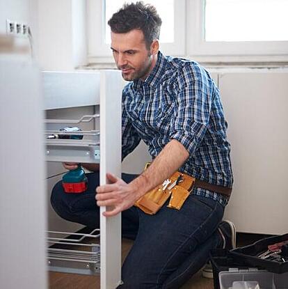 Handyman assembling furniture using small business automation tools to manage tasks and simplify scheduling